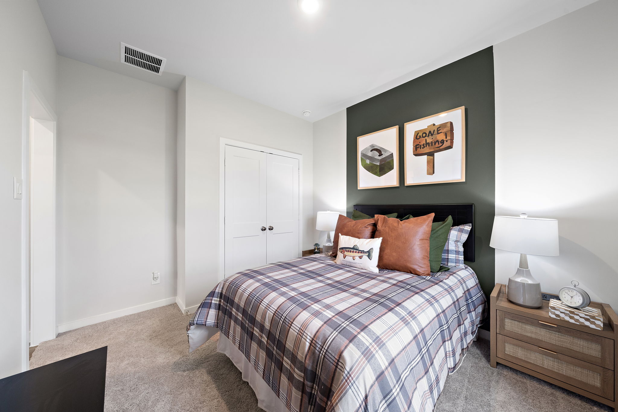 A bedroom with a bed and a dresser.