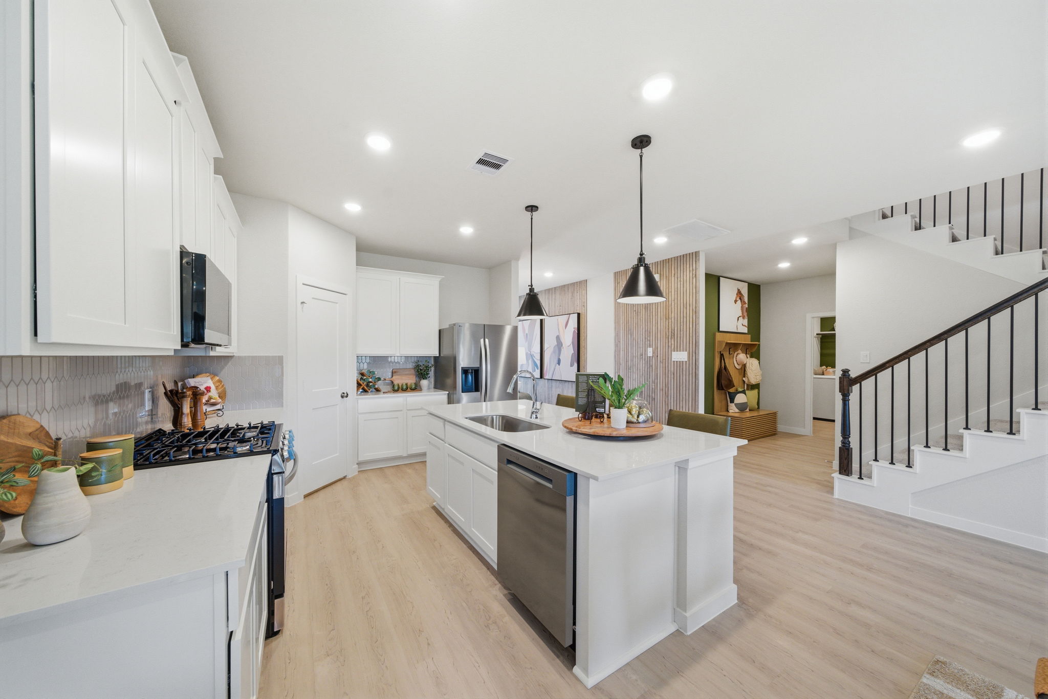 A kitchen with white cabinets.