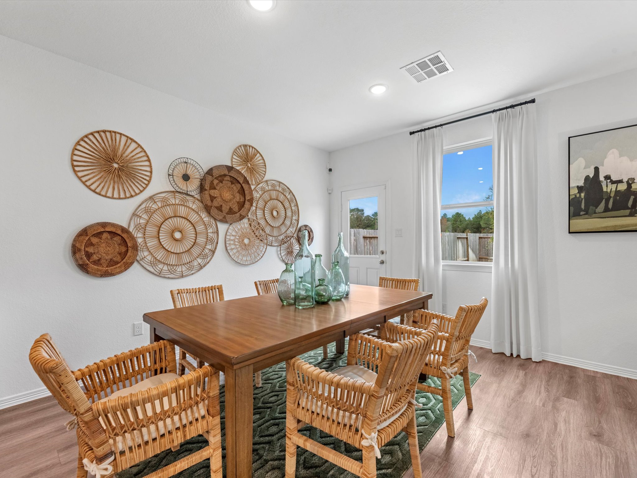 A dining room table with plates on it.