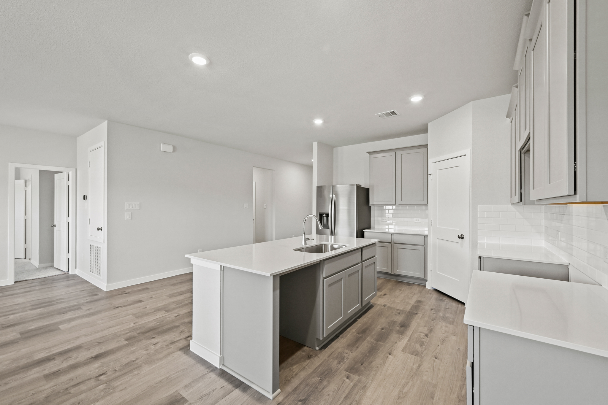 A kitchen with white cabinets.
