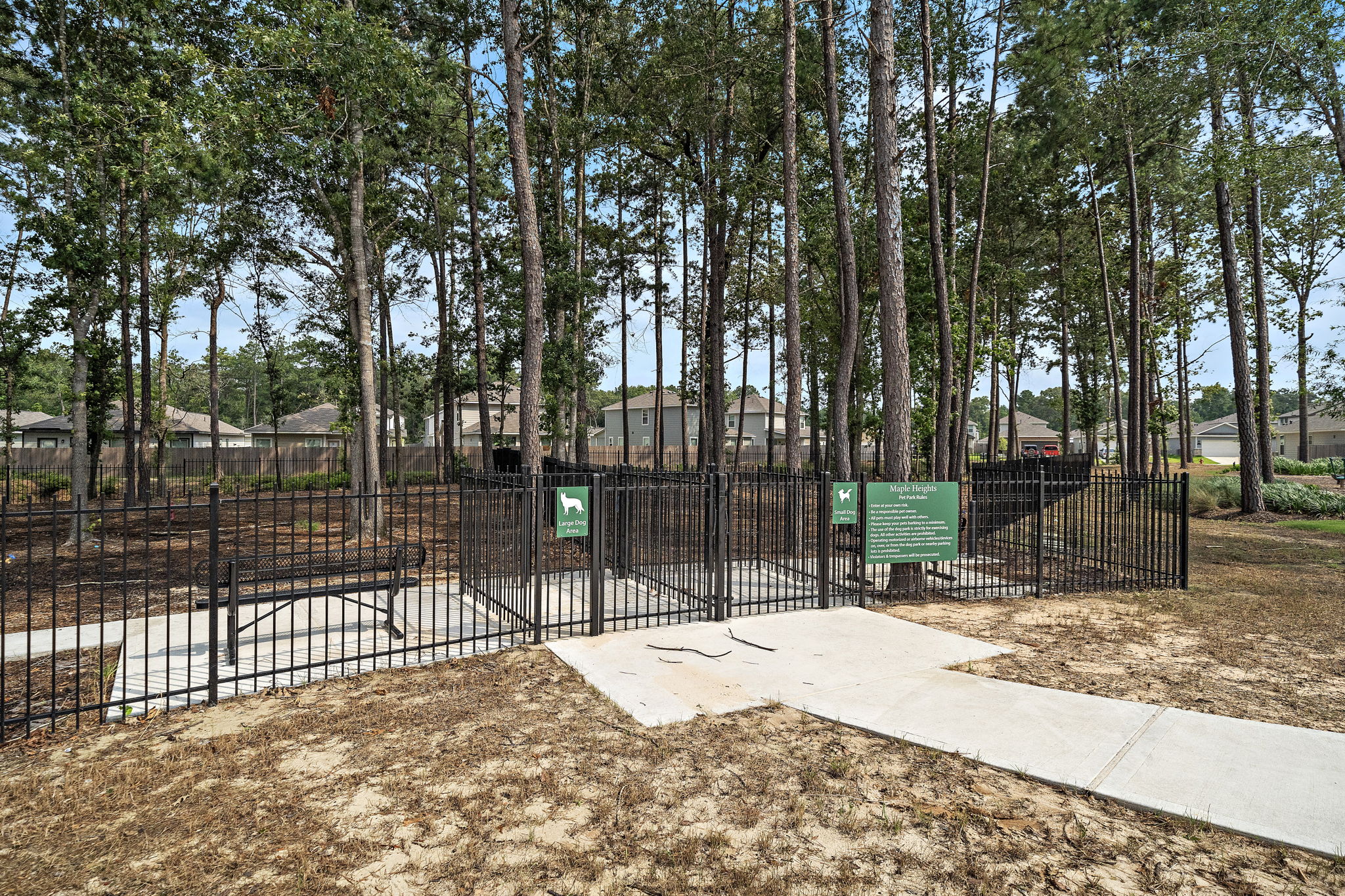 A fenced off area with trees in the back.