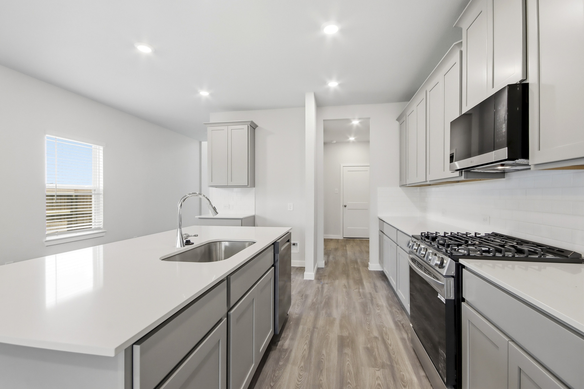 A kitchen with white cabinets.