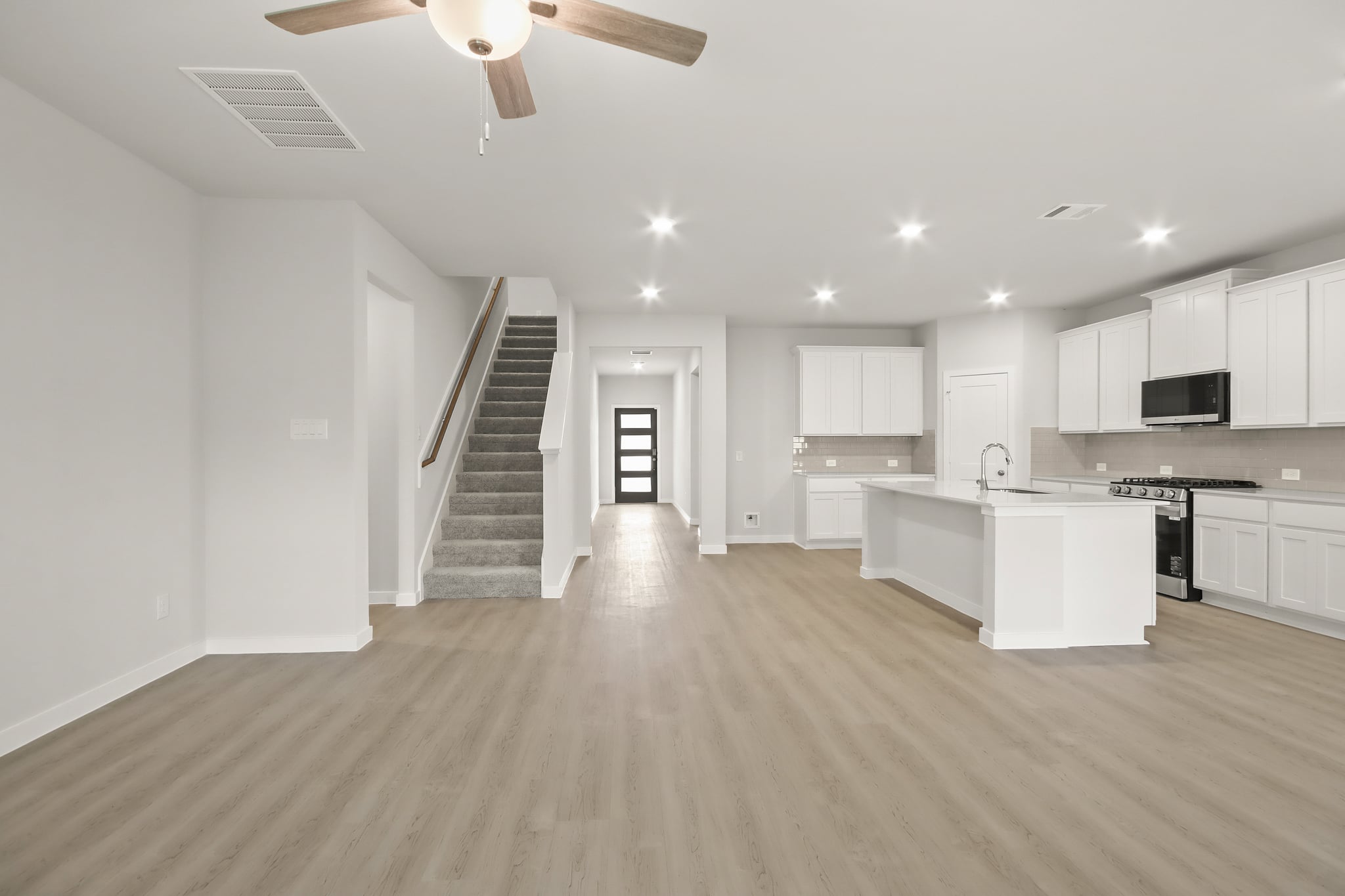A large kitchen with white cabinets.