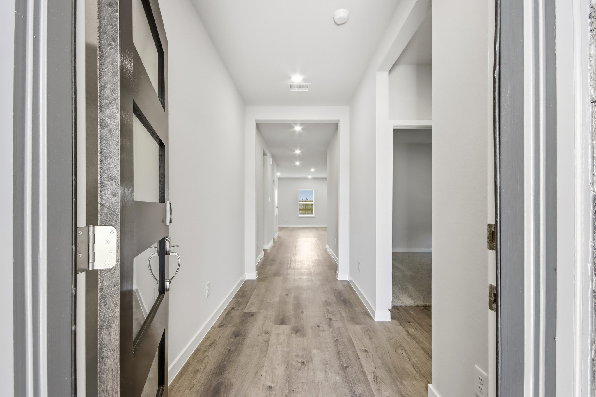 A hallway with white walls.