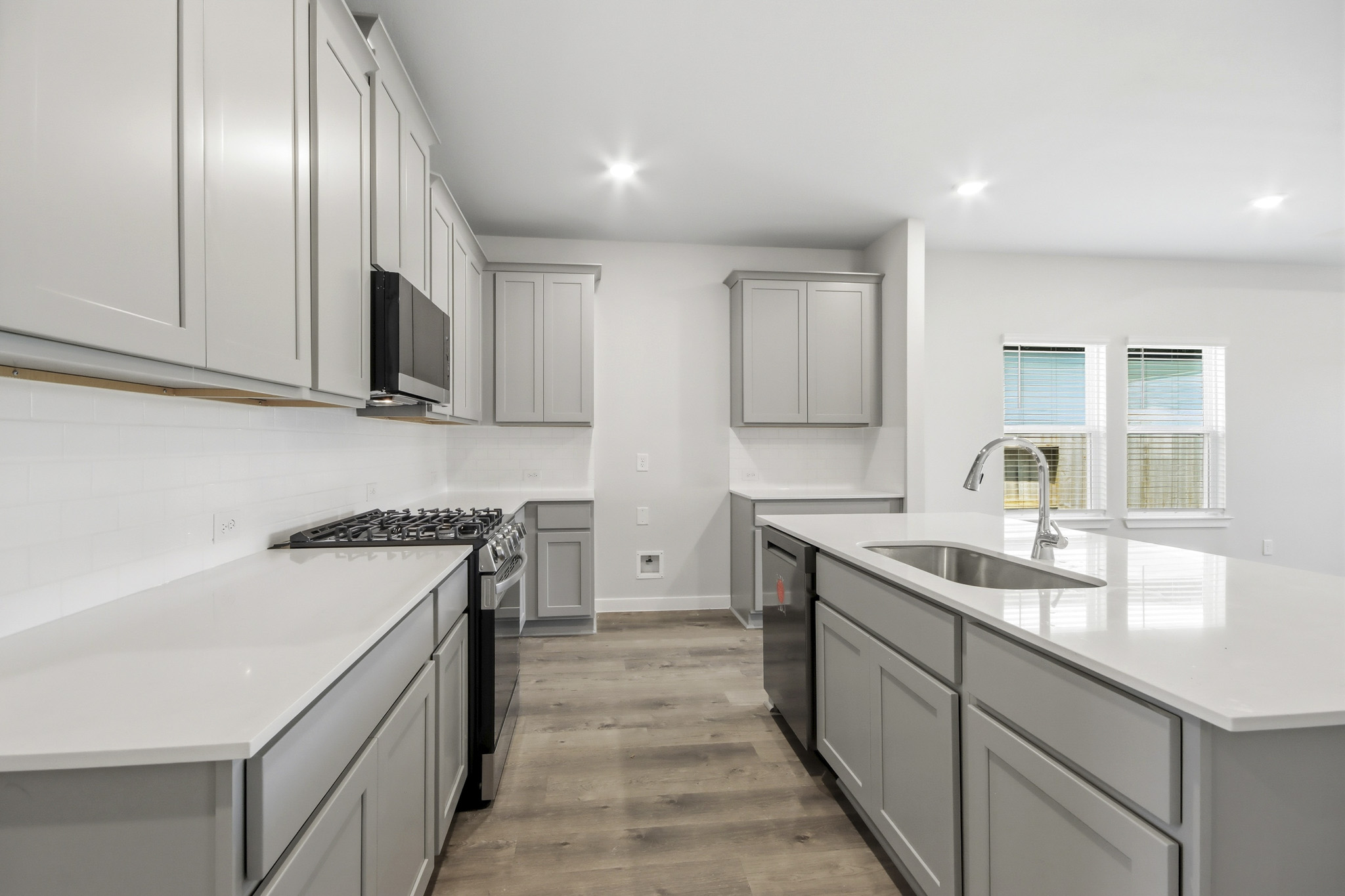 A kitchen with white cabinets.