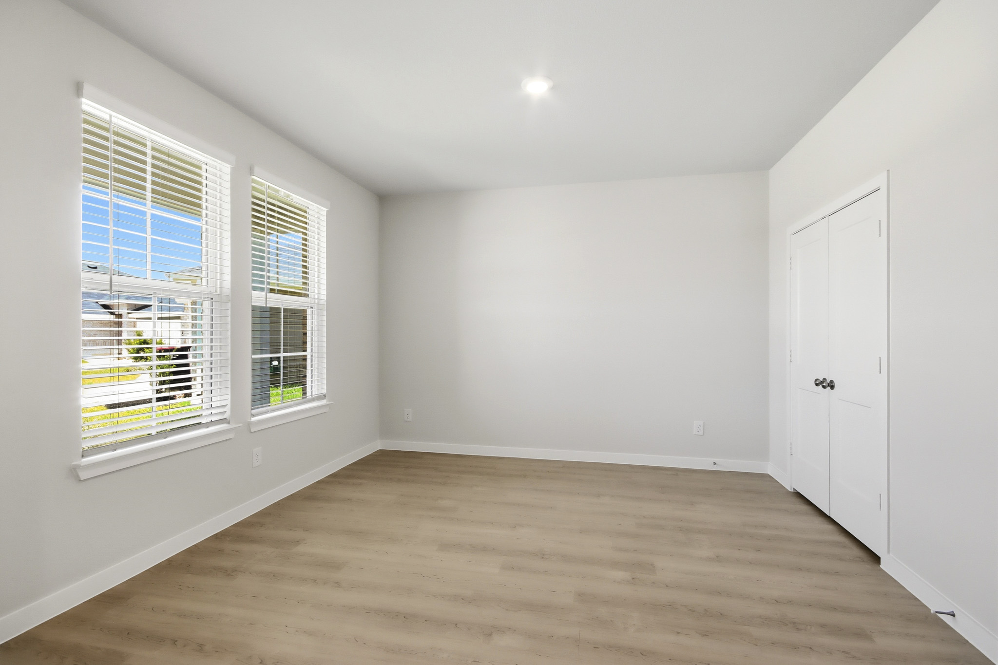A room with a wood floor and white walls.