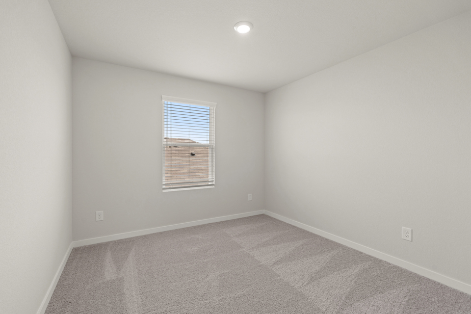A room with a window and a carpet.
