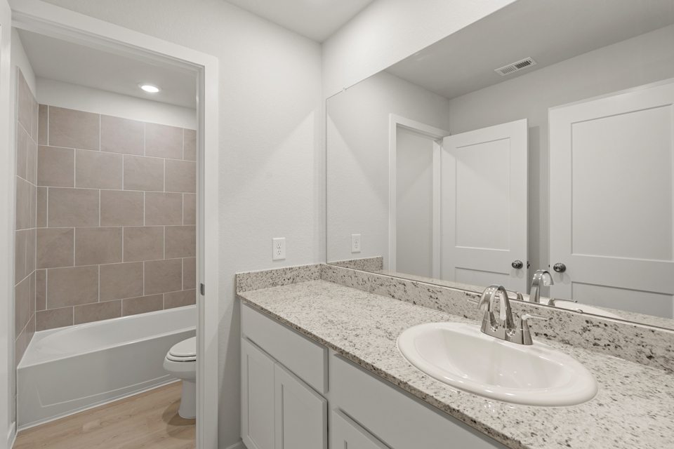 A bathroom with a marble countertop.