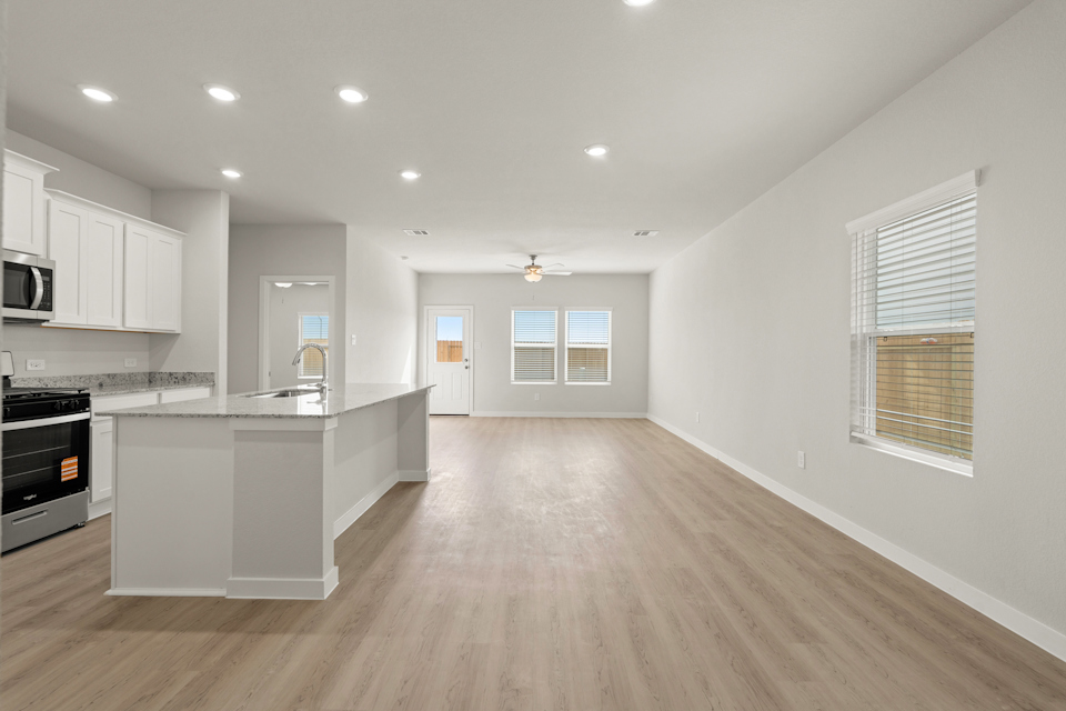 A kitchen with white cabinets.