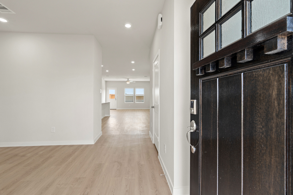 A hallway with a wood floor.