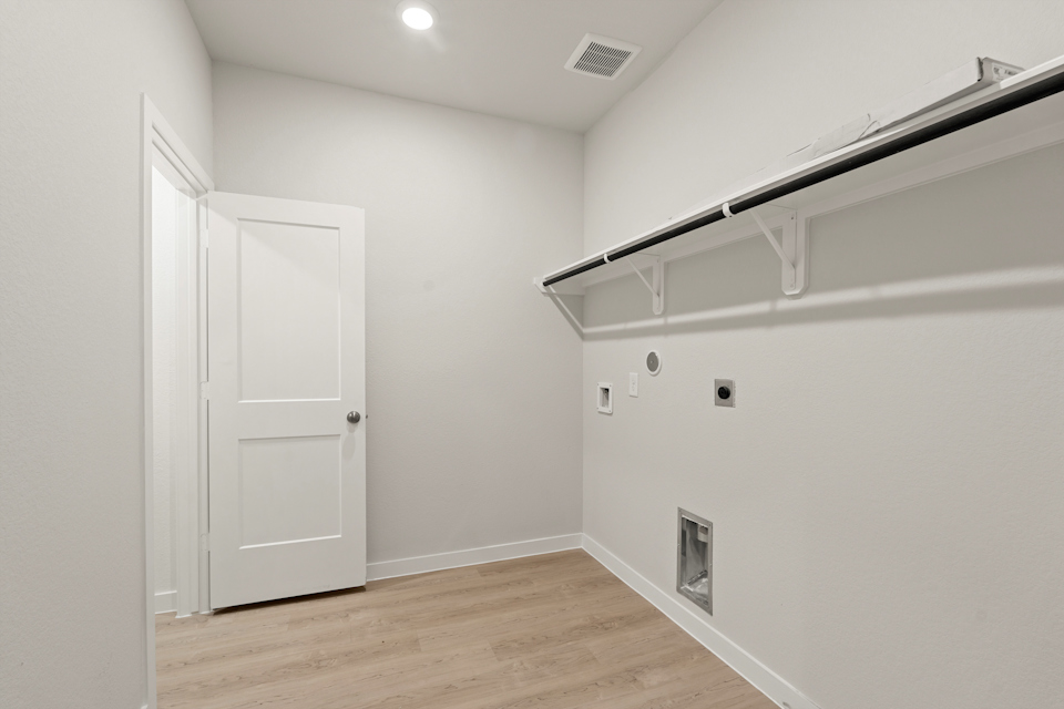 A room with white walls and a wood floor.