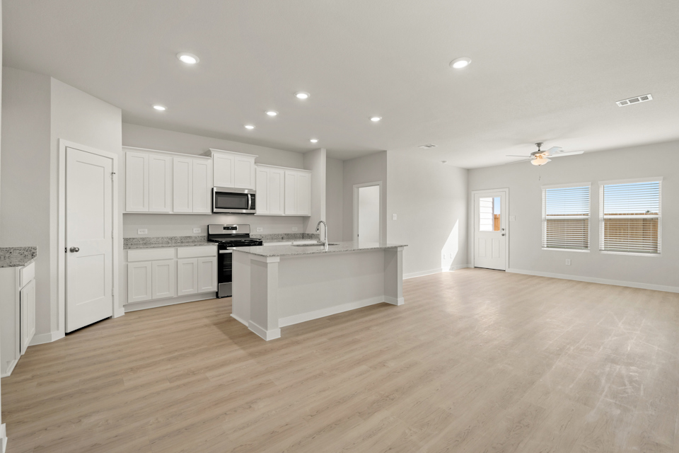 A large kitchen with white cabinets.