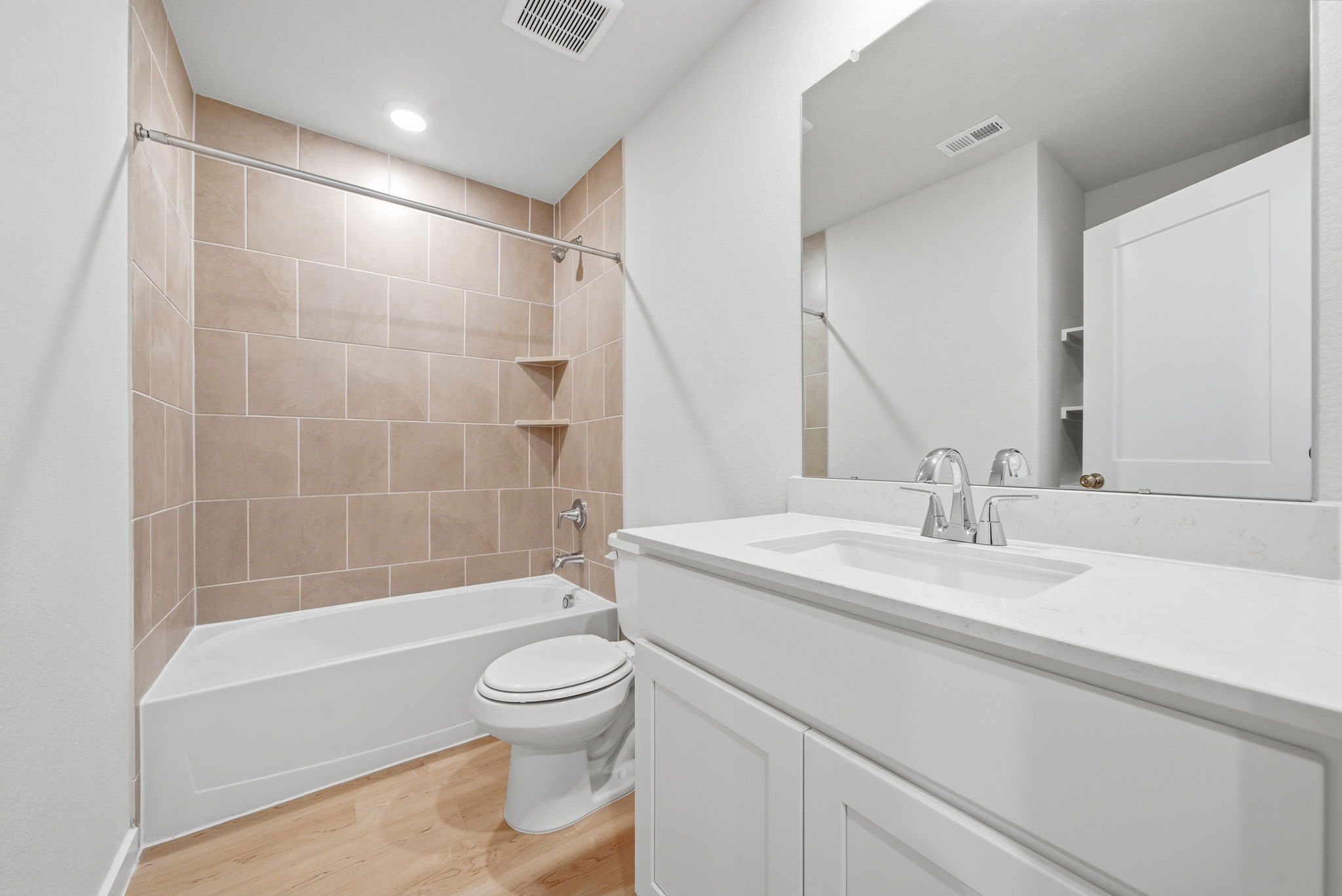 A bathroom with a tub sink and toilet.