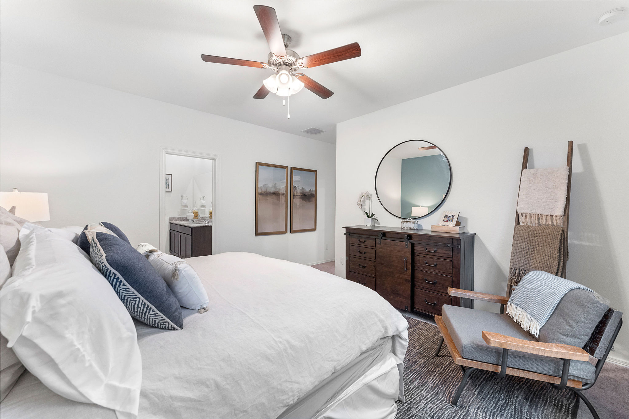 A bedroom with a bed and a fan.