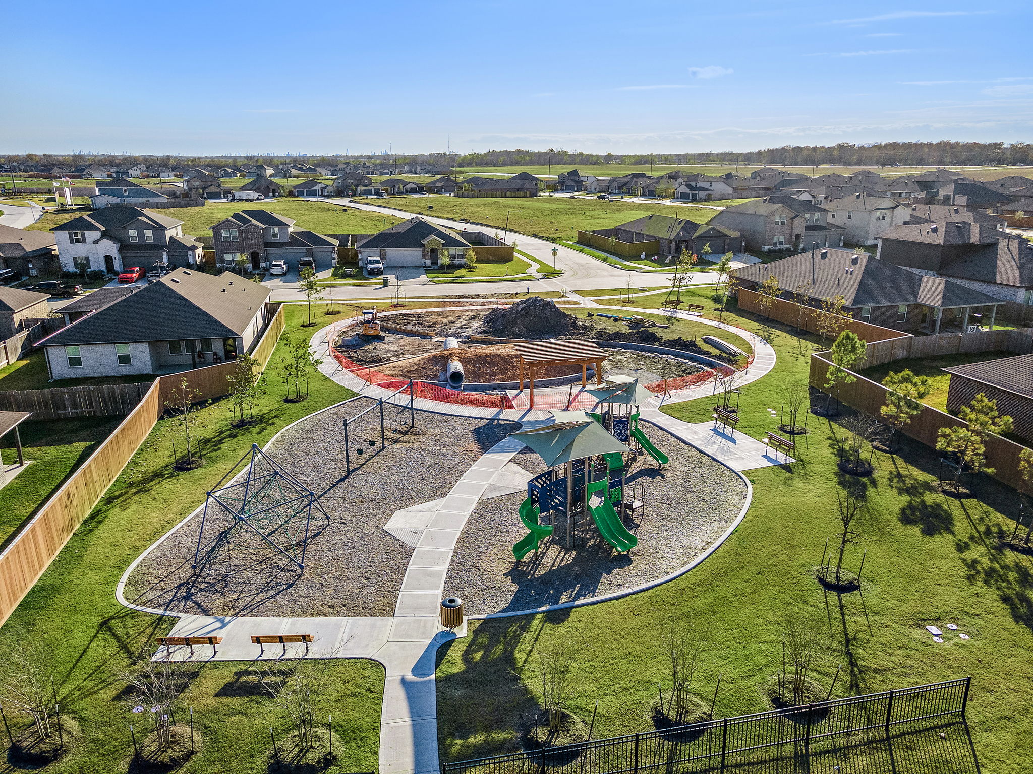 A large courtyard with a fountain and buildings in the background.