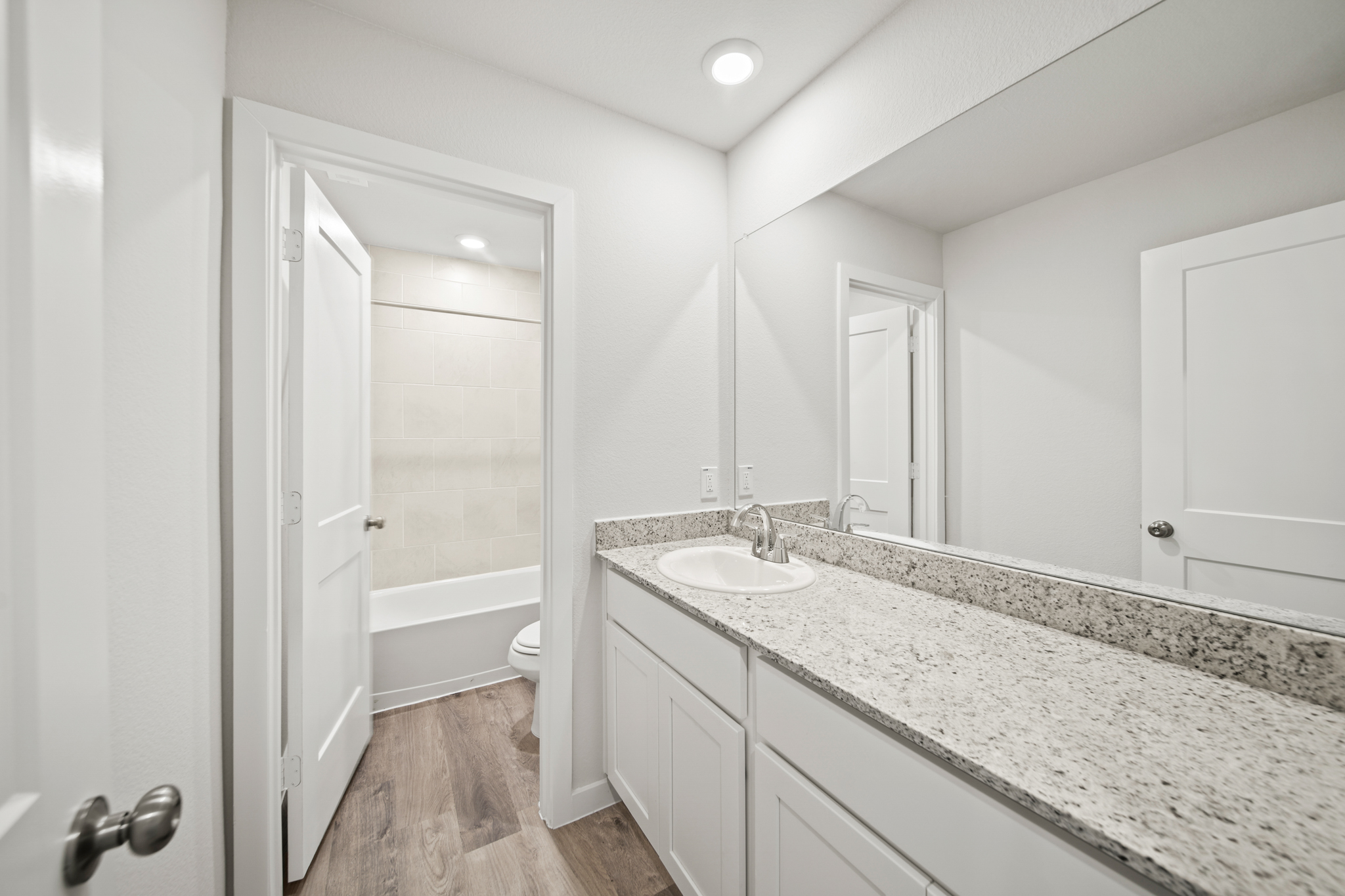 A bathroom with a marble countertop.