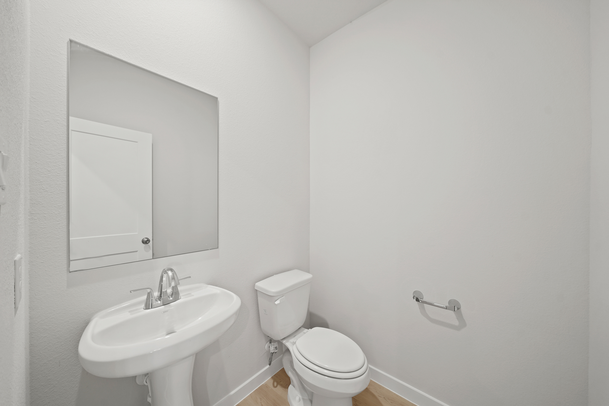 A bathroom with a toilet and sink.