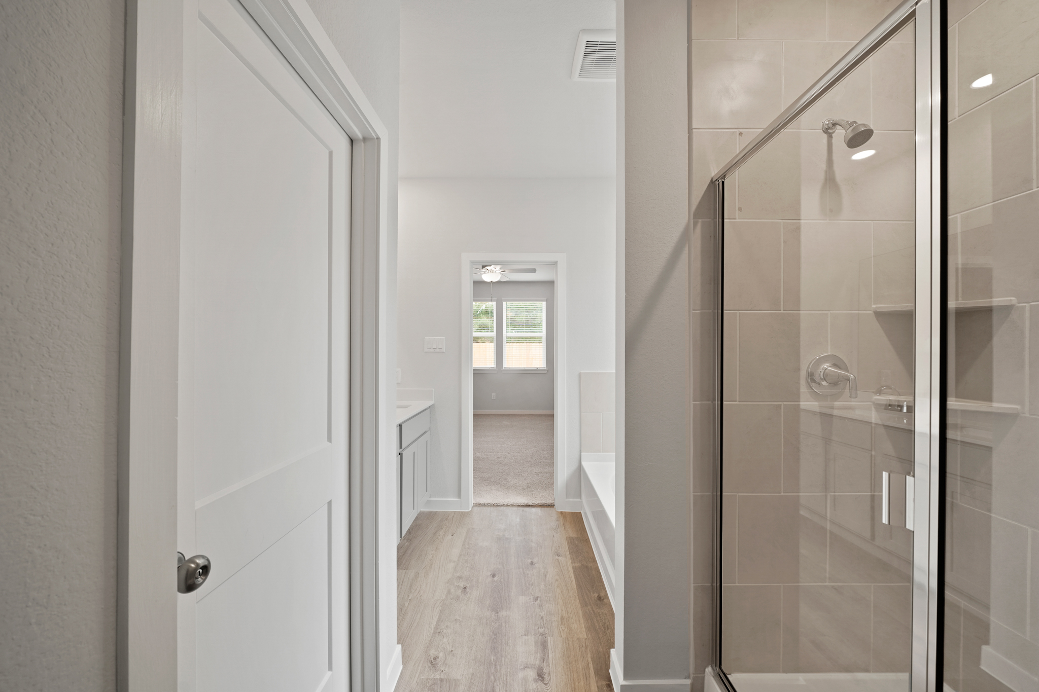 A shower with a glass door.