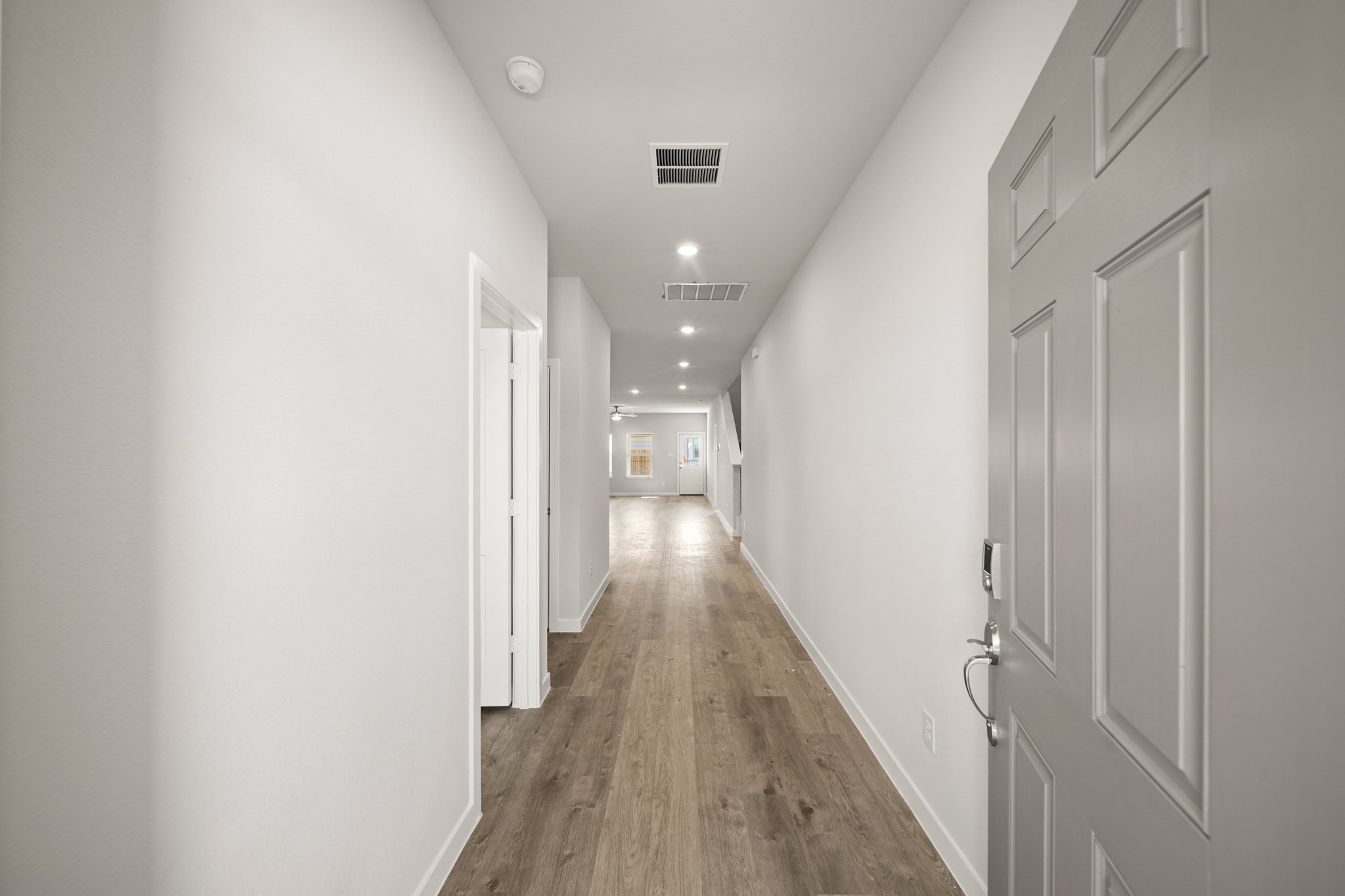 A hallway with white doors.