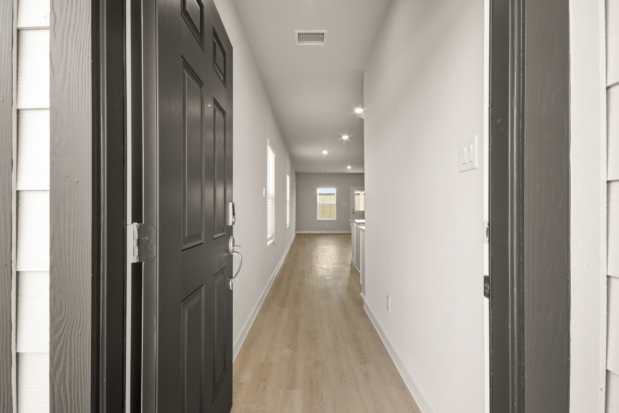 A hallway with black doors.