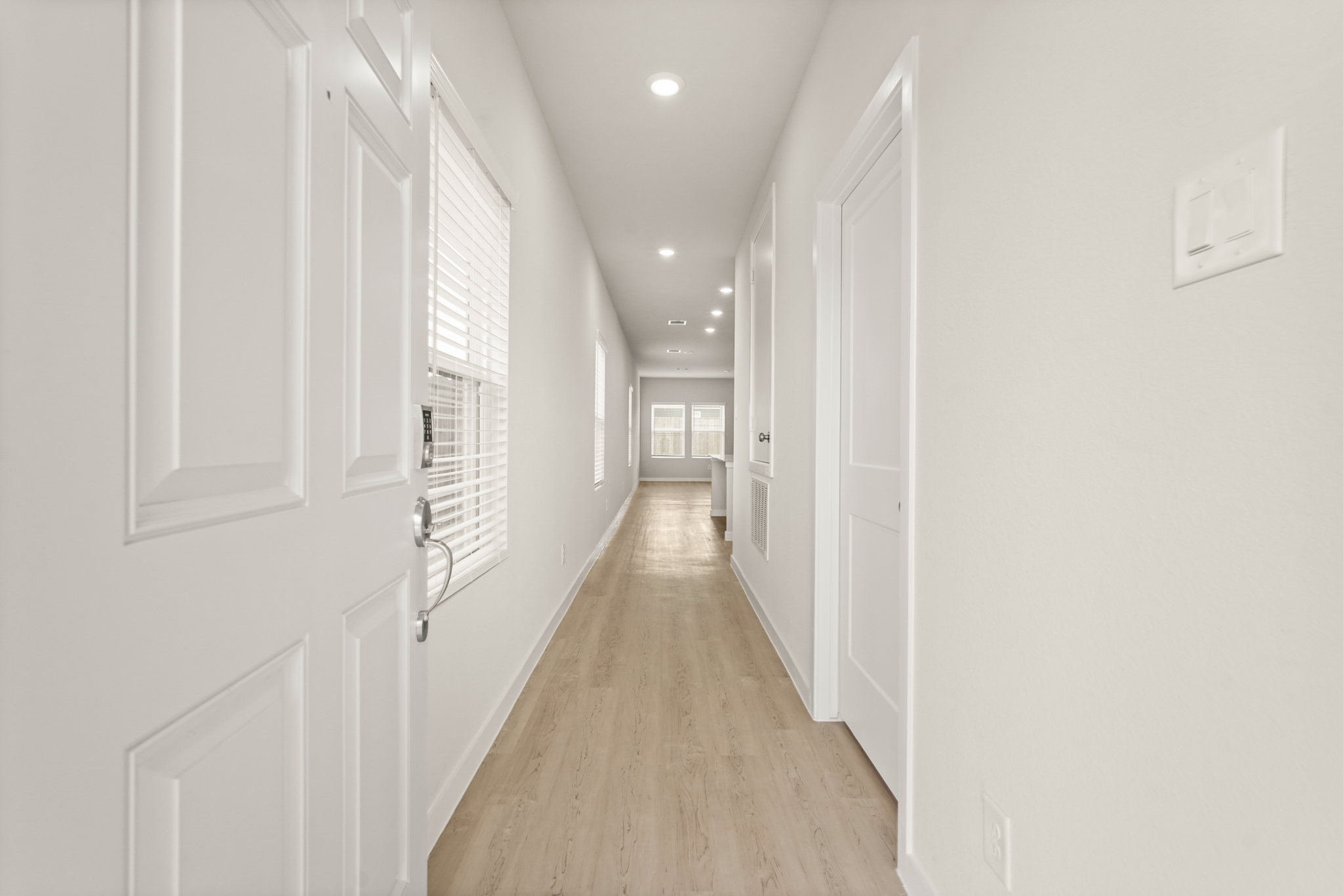 A hallway with white doors.