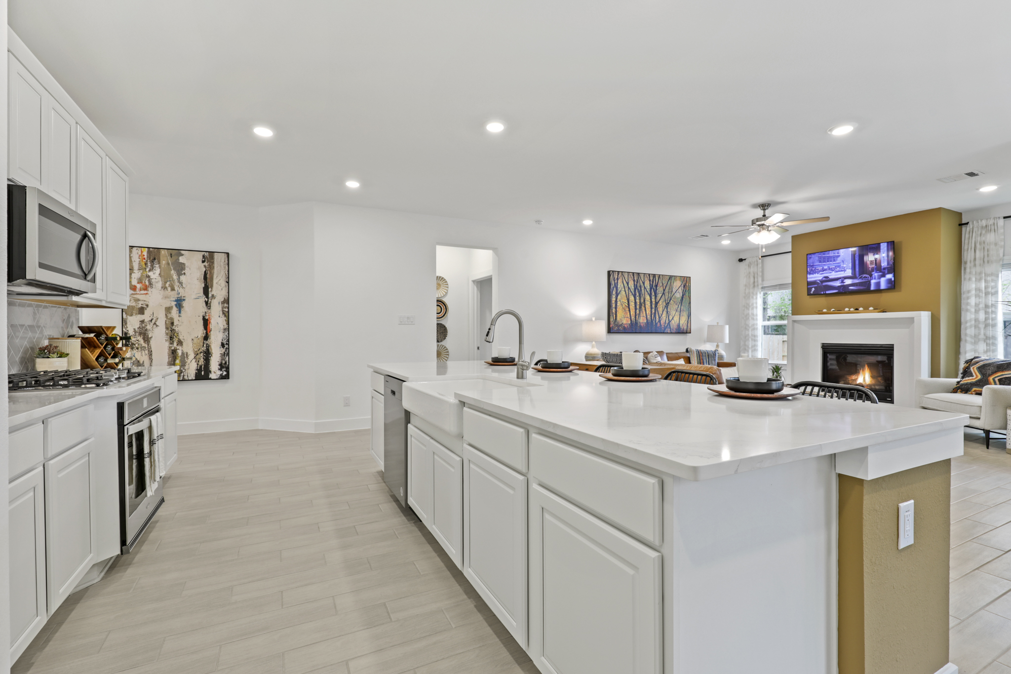 A kitchen with white cabinets.