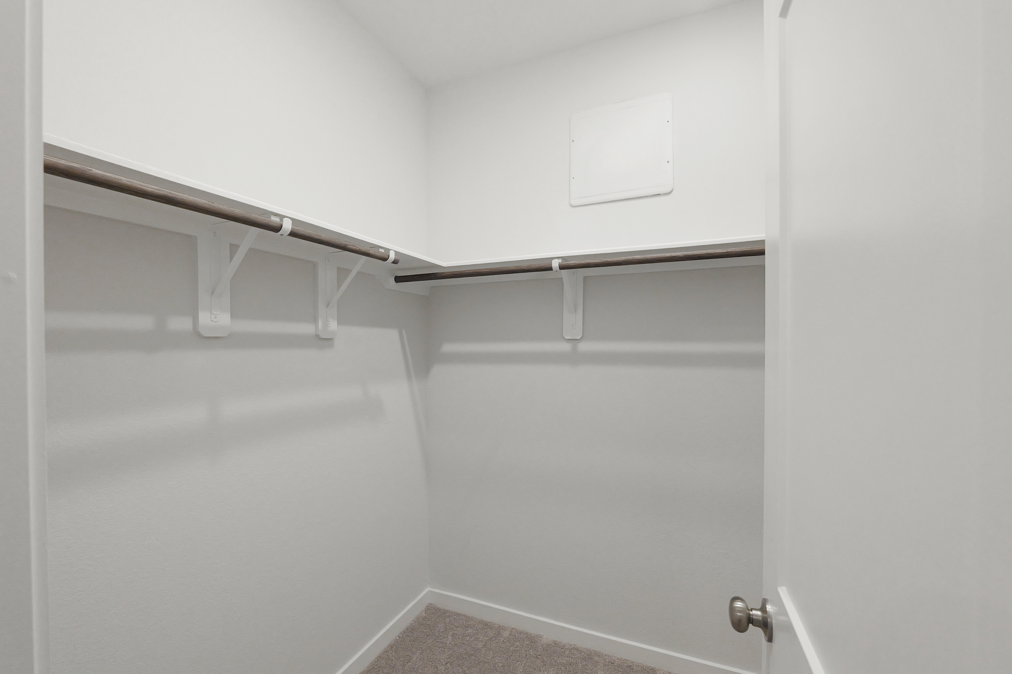 A white door with a metal bar.