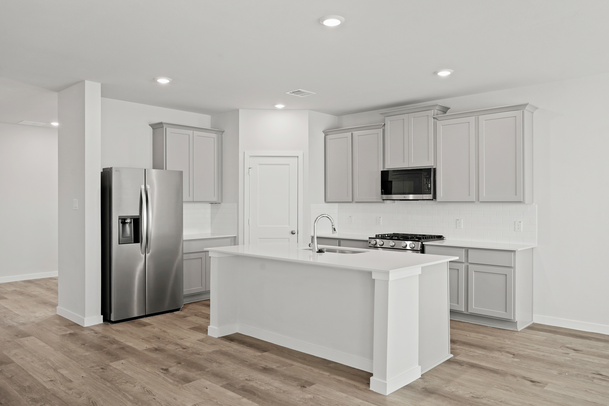 A kitchen with white cabinets.