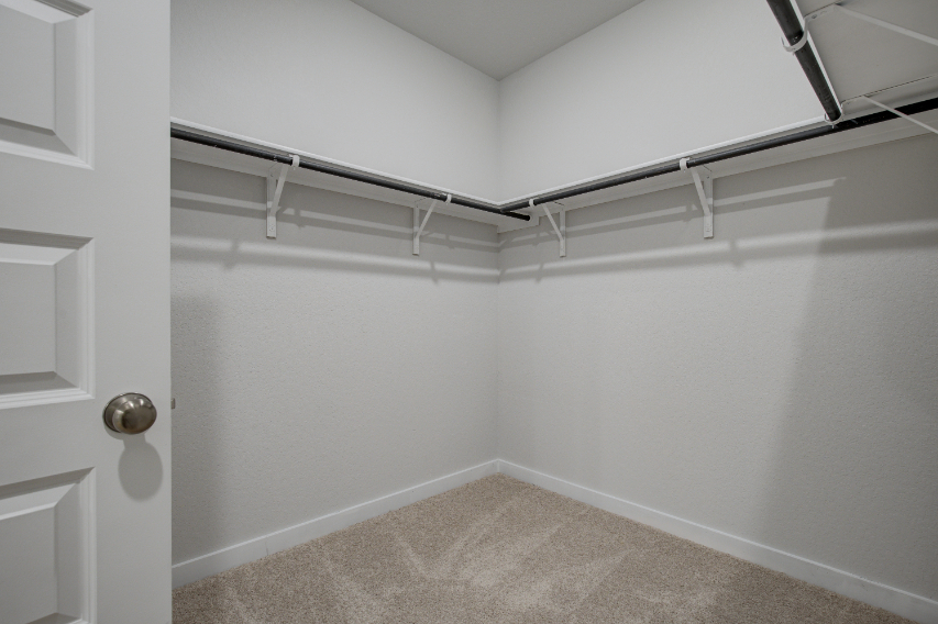 A white room with a metal railing.