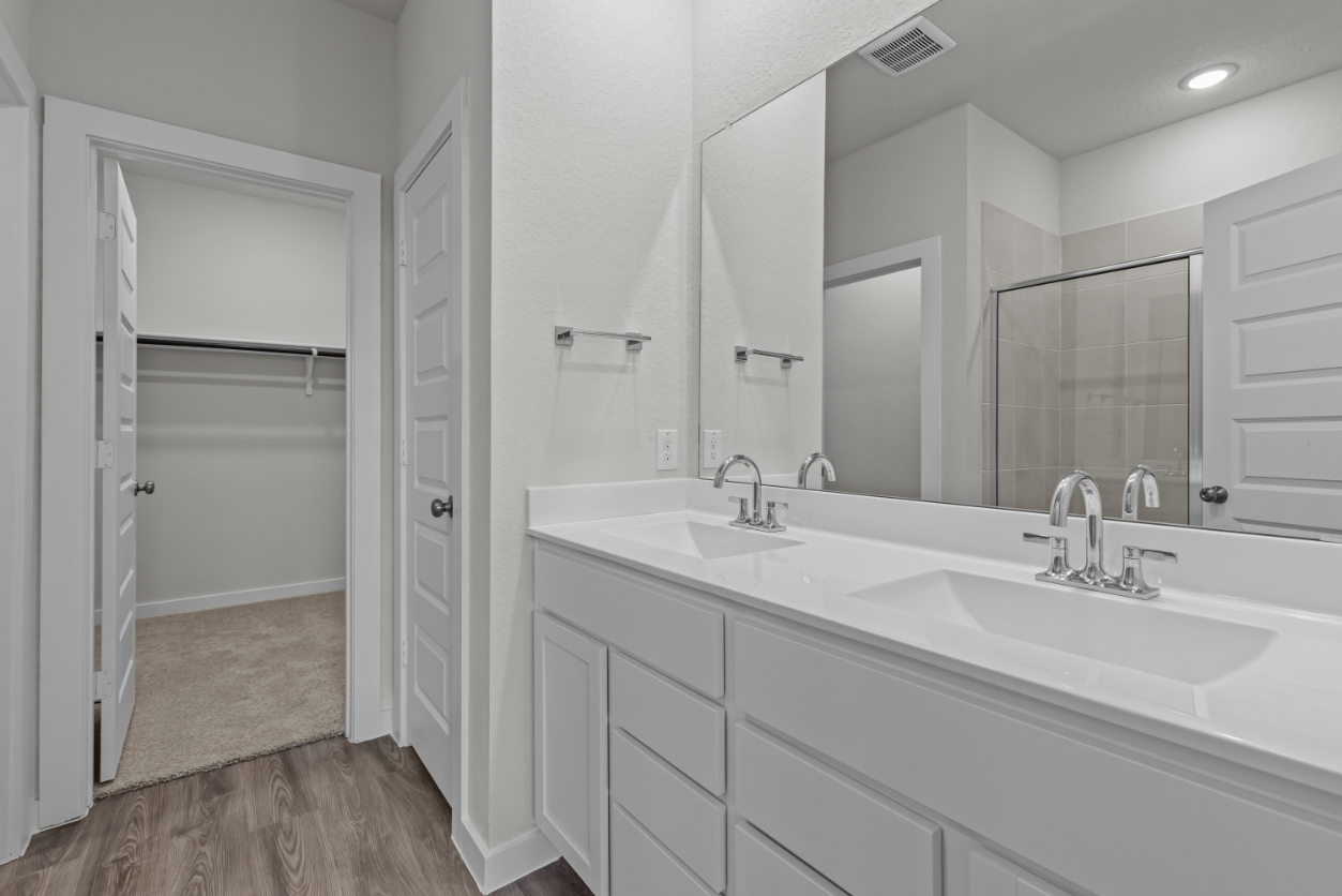 A bathroom with a large mirror.