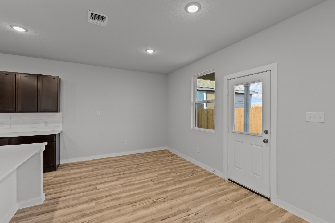 A room with a wood floor and a white door.