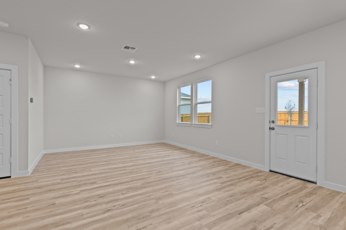 A room with a wood floor and white walls.