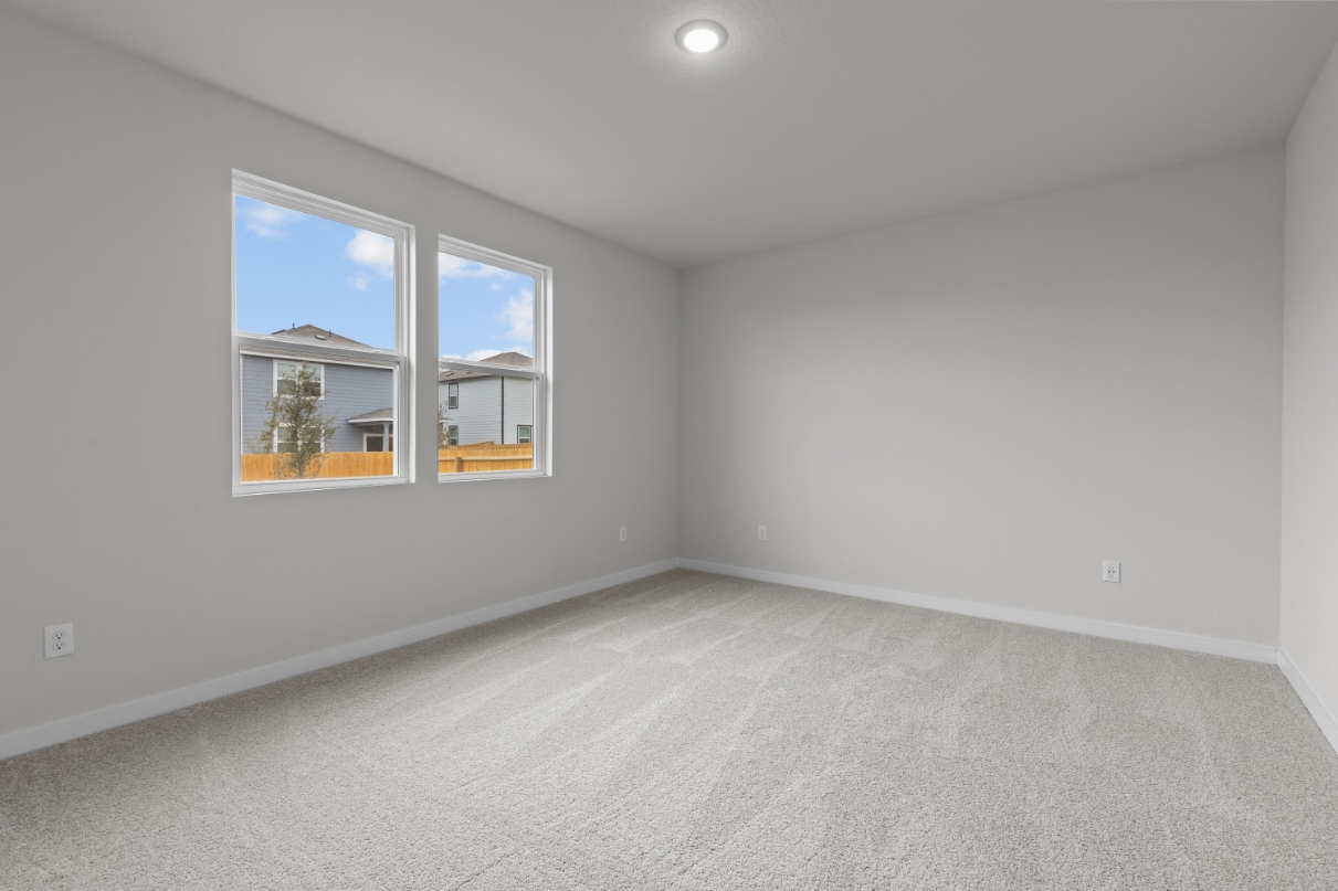 A room with a window and a white wall with a white floor.