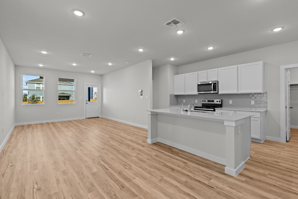 A kitchen with white cabinets.