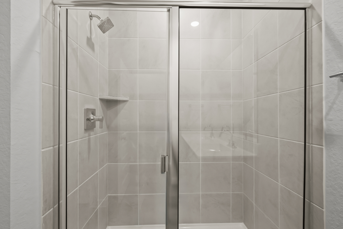 A shower with glass doors.