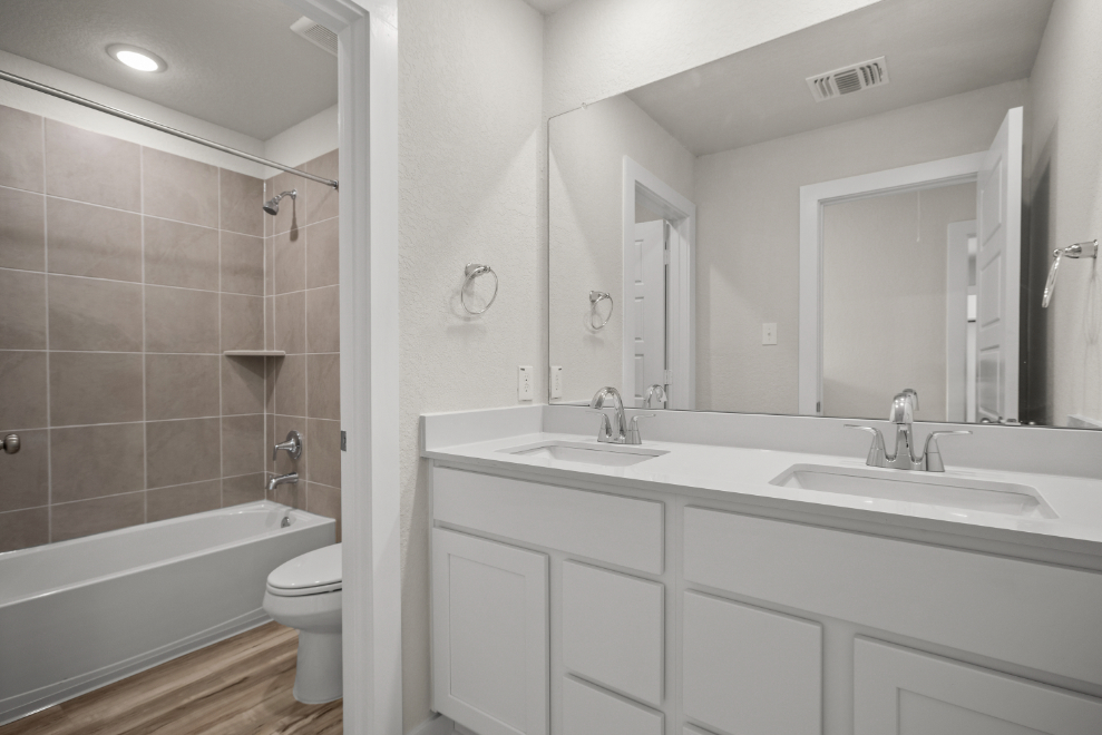 A bathroom with a tub sink and toilet.