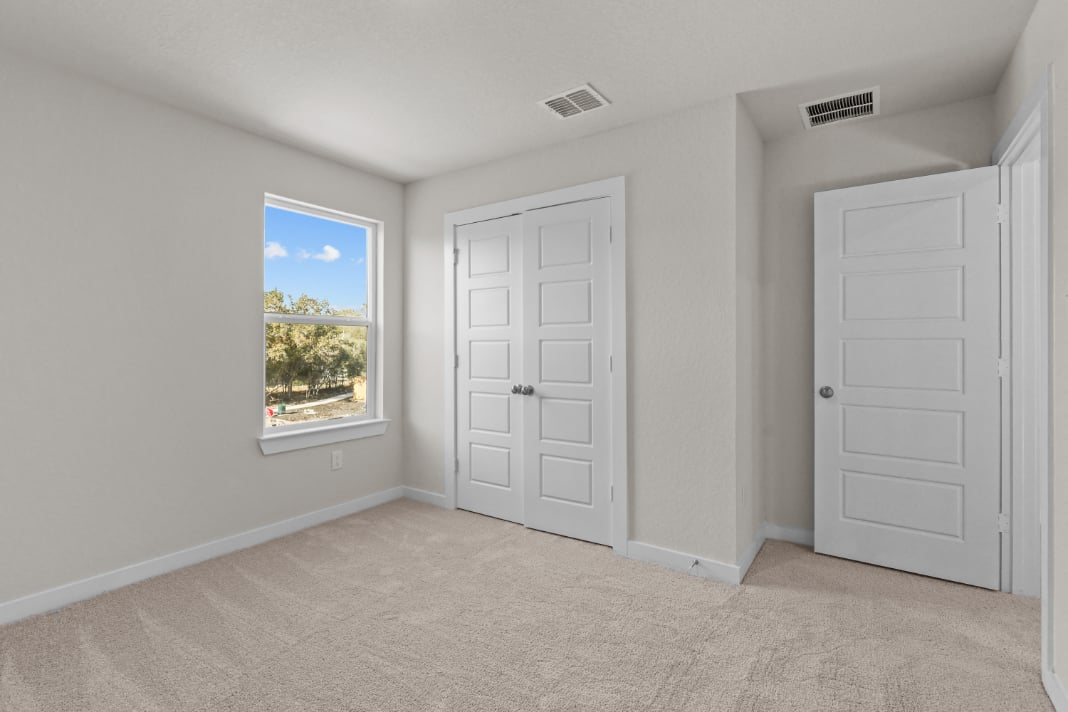A room with white doors and a window.
