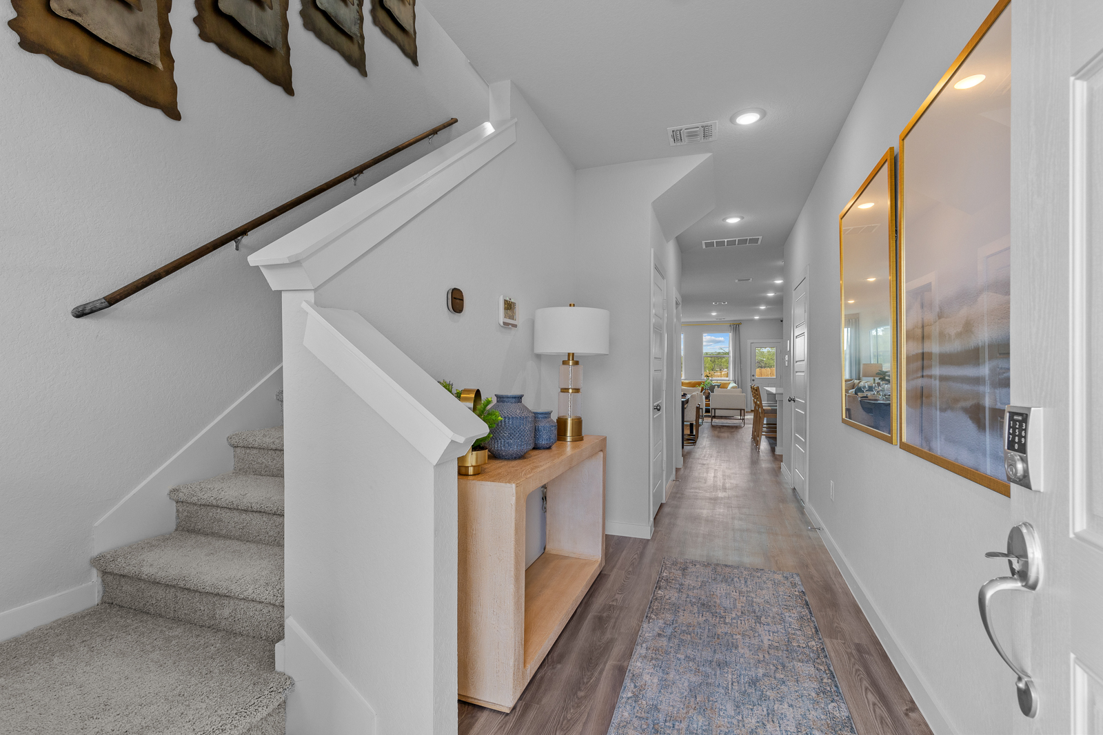 A bathroom with a table and a lamp.