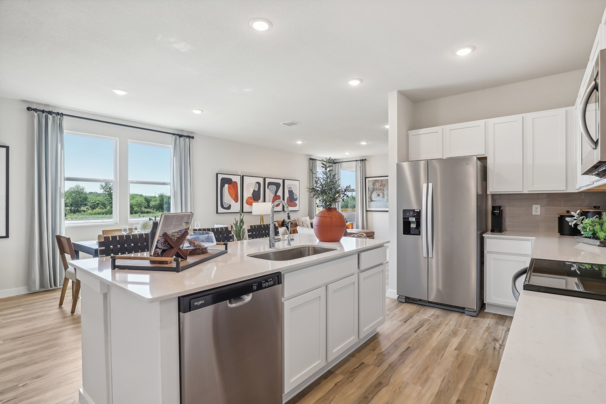 A kitchen with white cabinets.