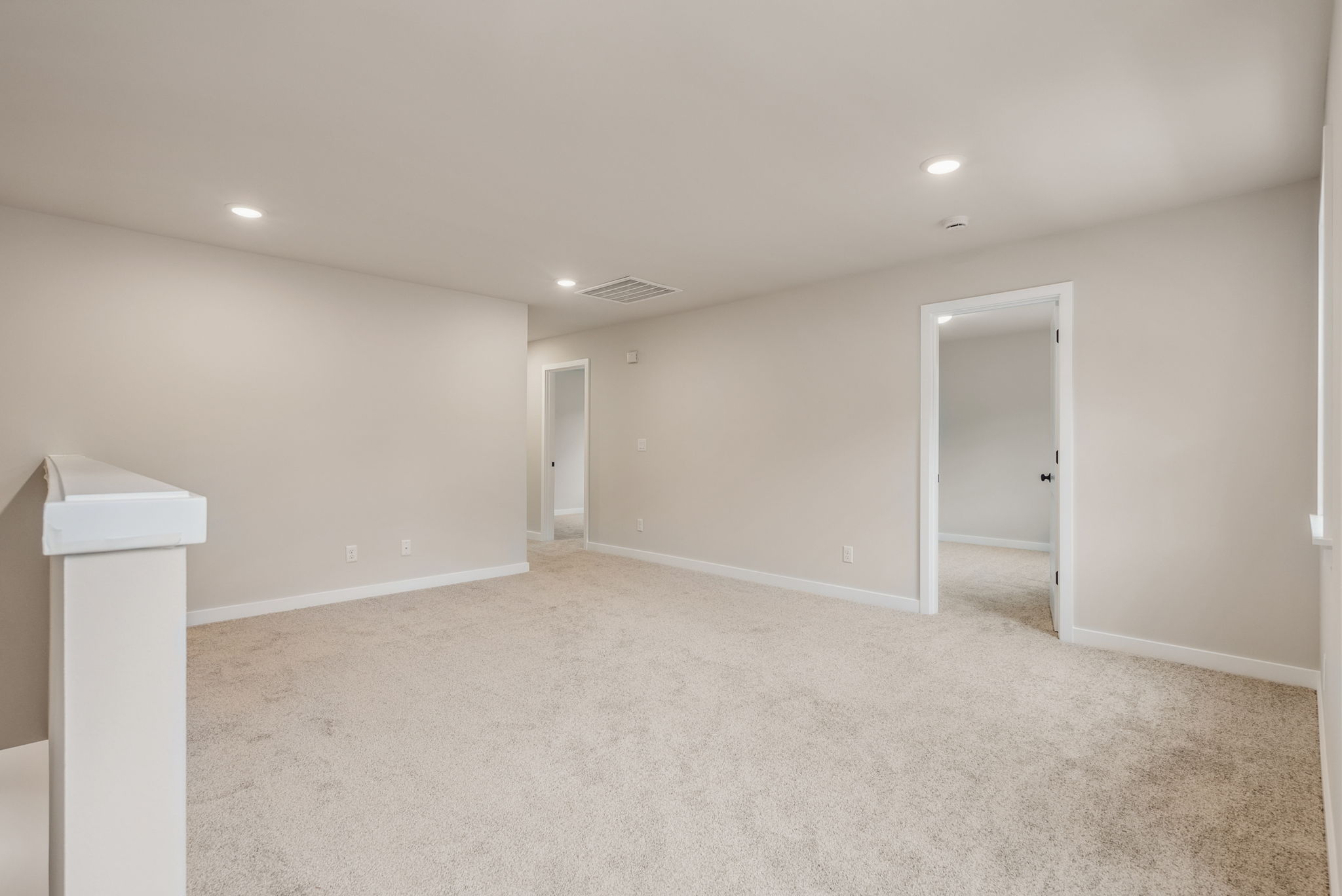 A room with a white door and a white table.