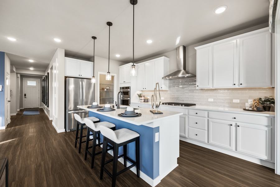 A kitchen with white cabinets.