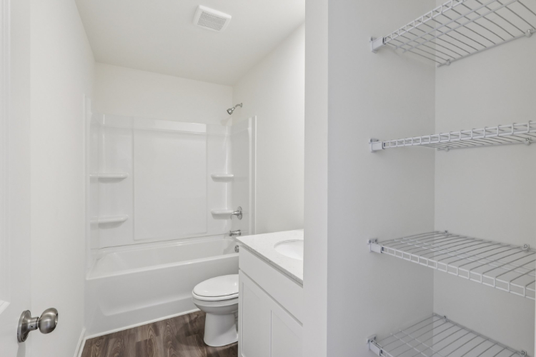 A bathroom with a tub toilet and sink.