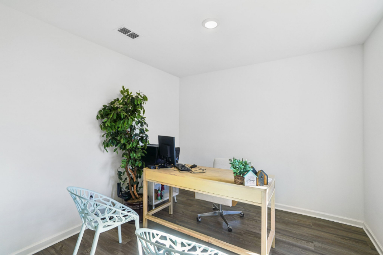 A room with a desk and chair.