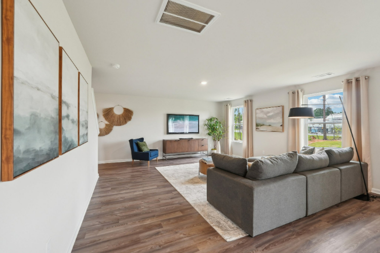 A living room with a couch and a tv.