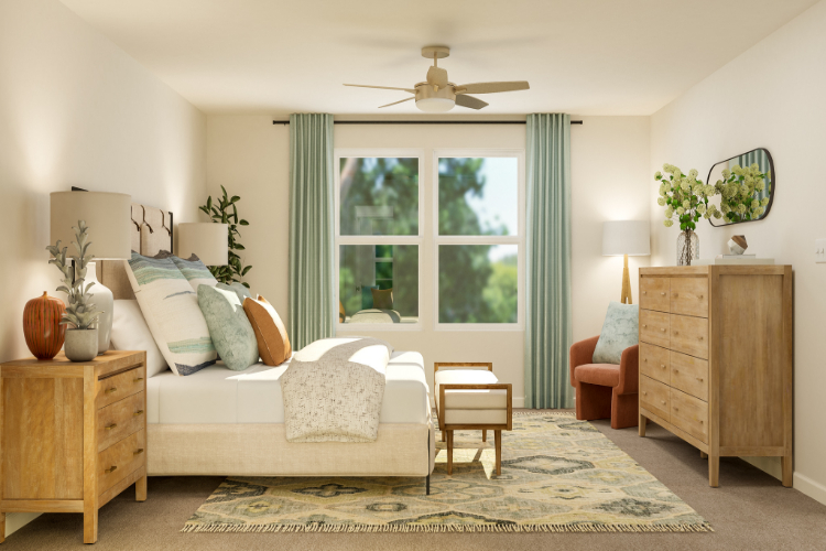 A living room with a couch and a fan.