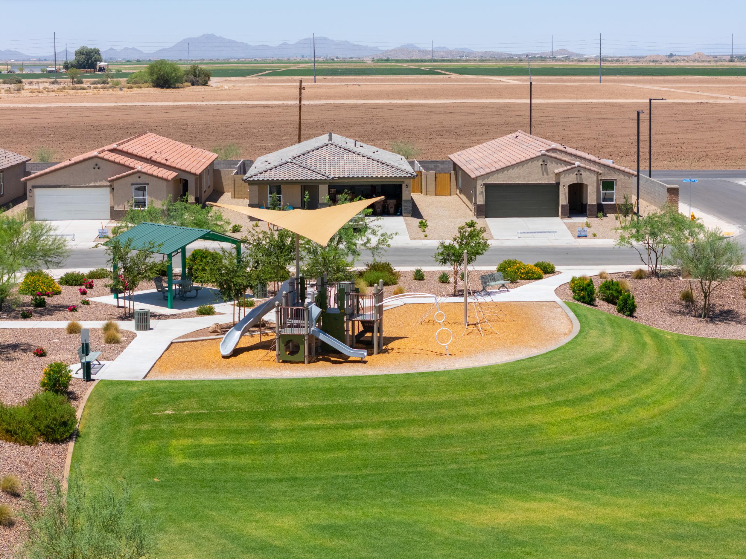 A golf course with a few buildings.
