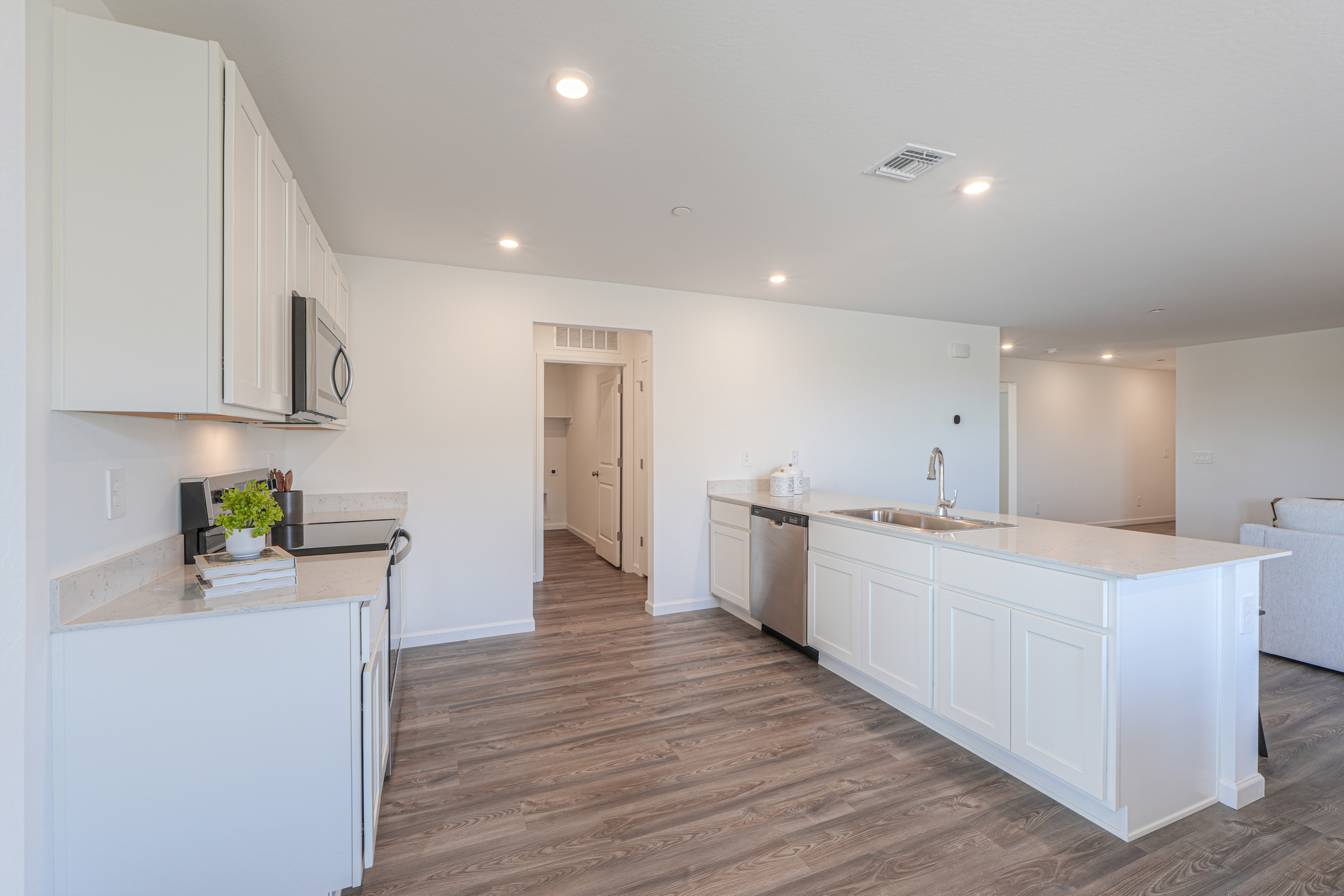 A kitchen with white cabinets.