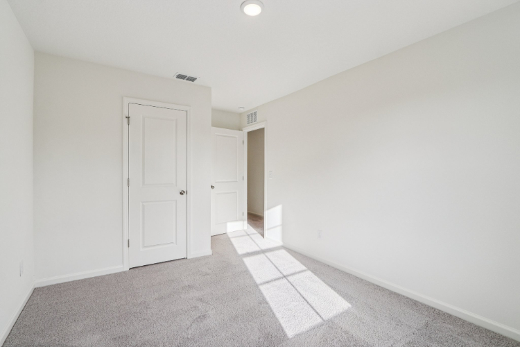 A hallway with white doors.
