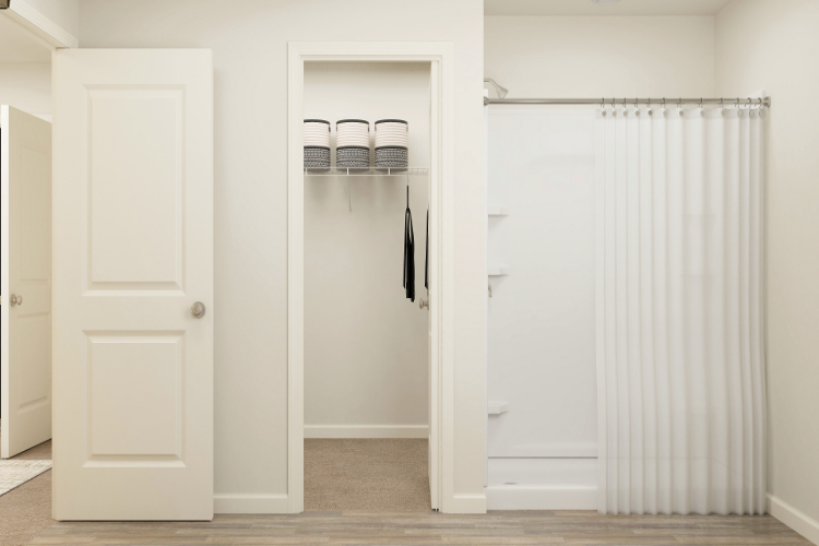 A closet with white doors.