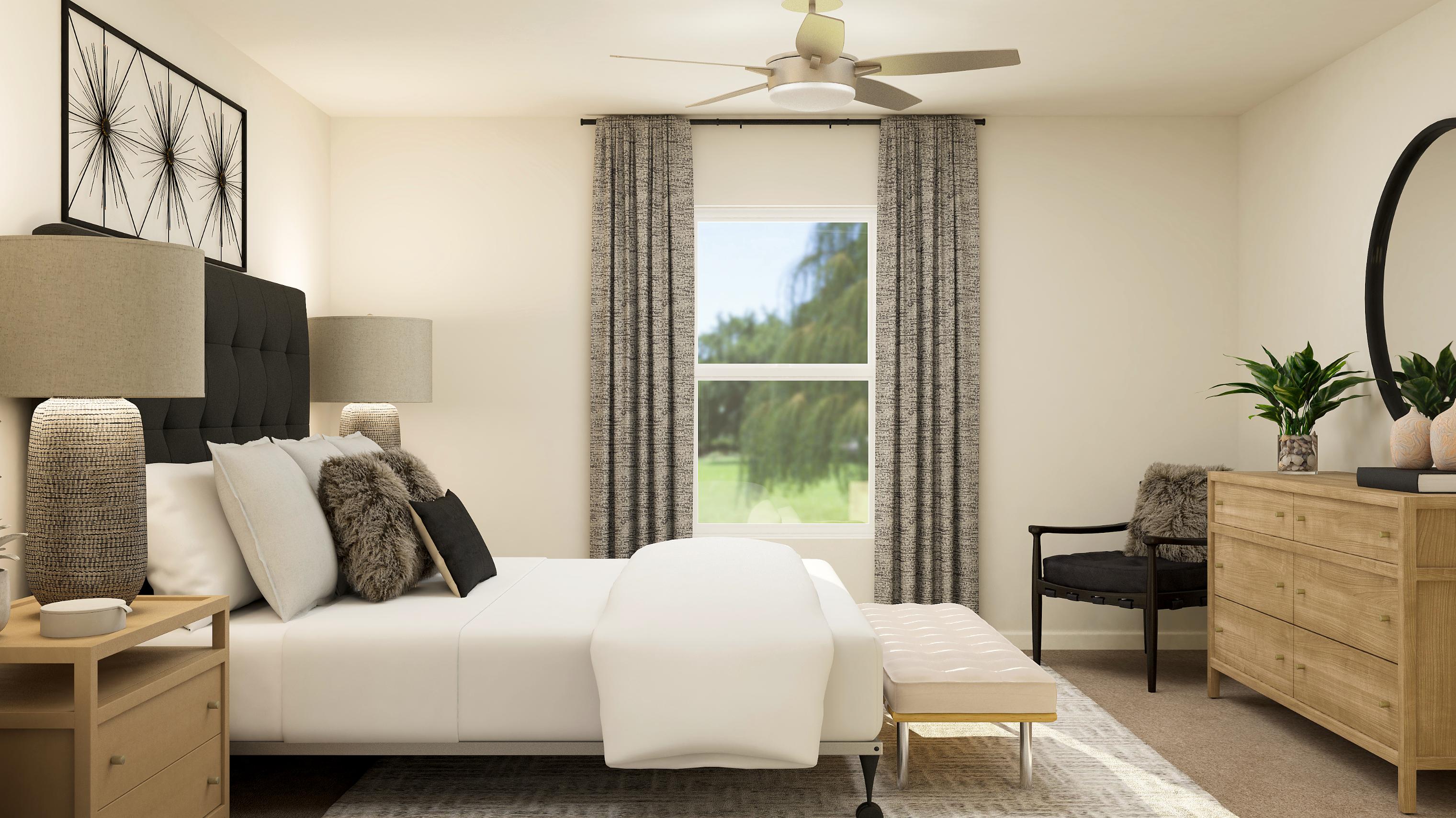 A living room with a white couch and a black chair.